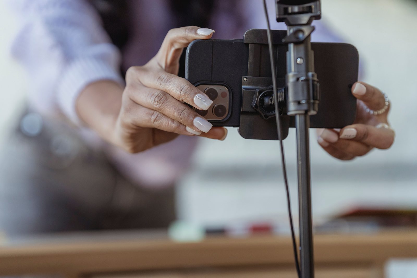 Creator setting up a phone on a tripod to film content